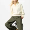 Løs polo-sweater i glat bomuld til kvinder